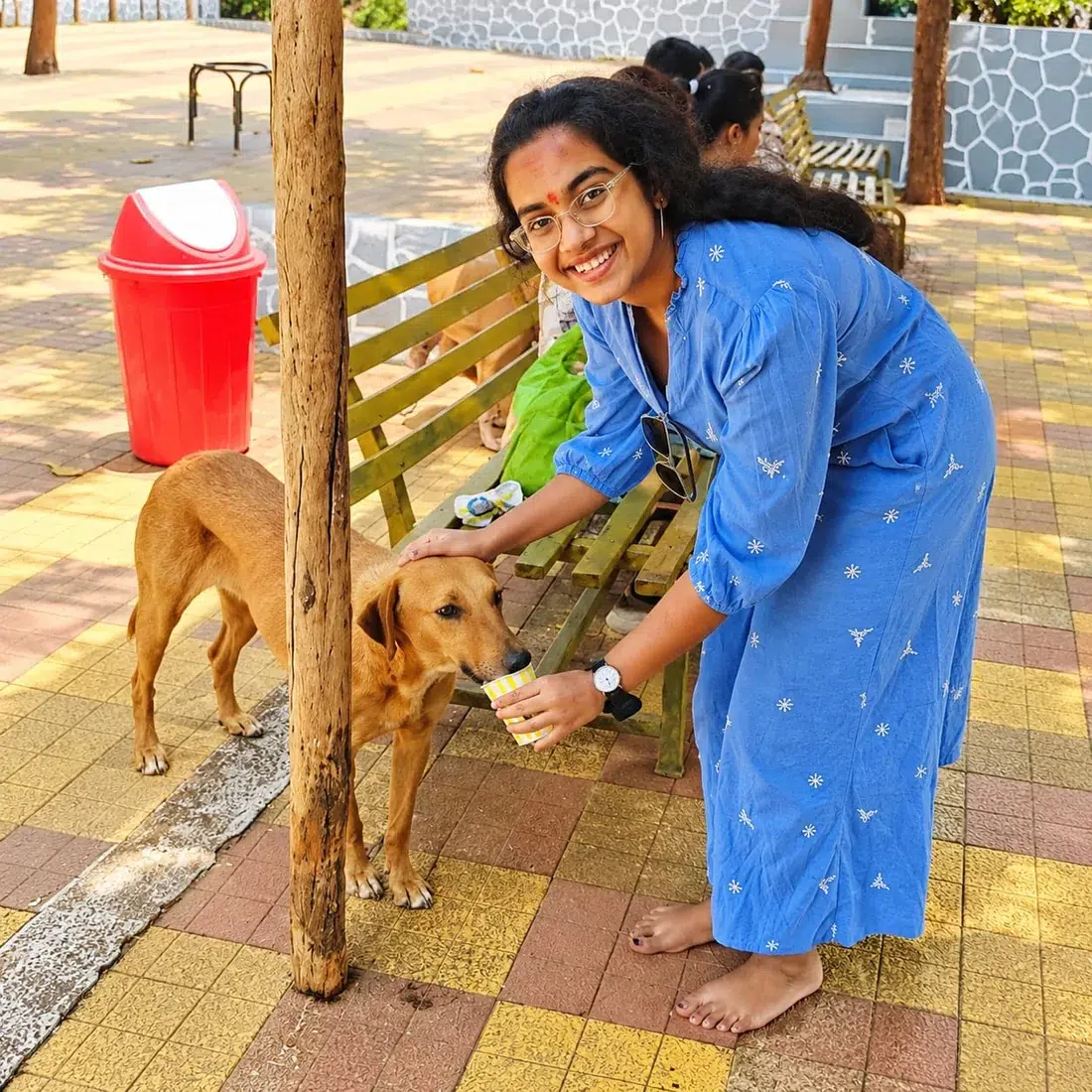 Community member gently holding a dog during animal welfare support